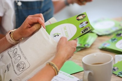 A hand putting seeds into a plastic bag